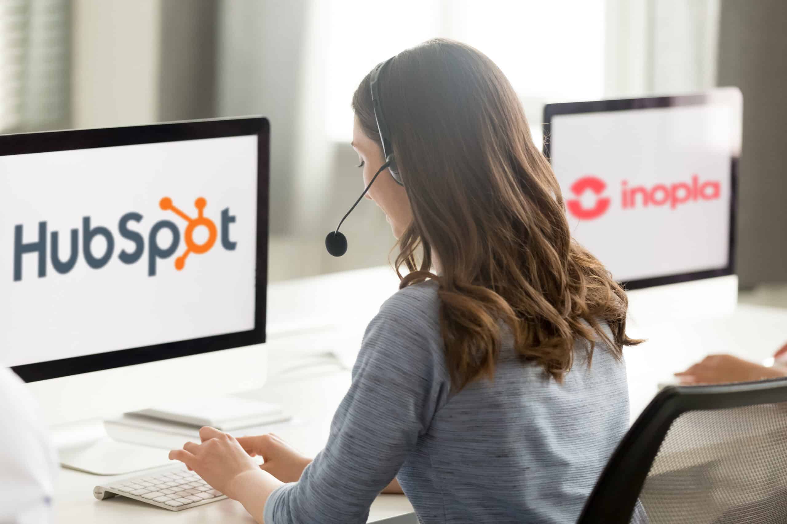 Mitarbeiter am PC mit HubSpot und inopla Logo